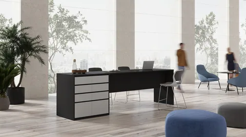 A standing height table in an office break area