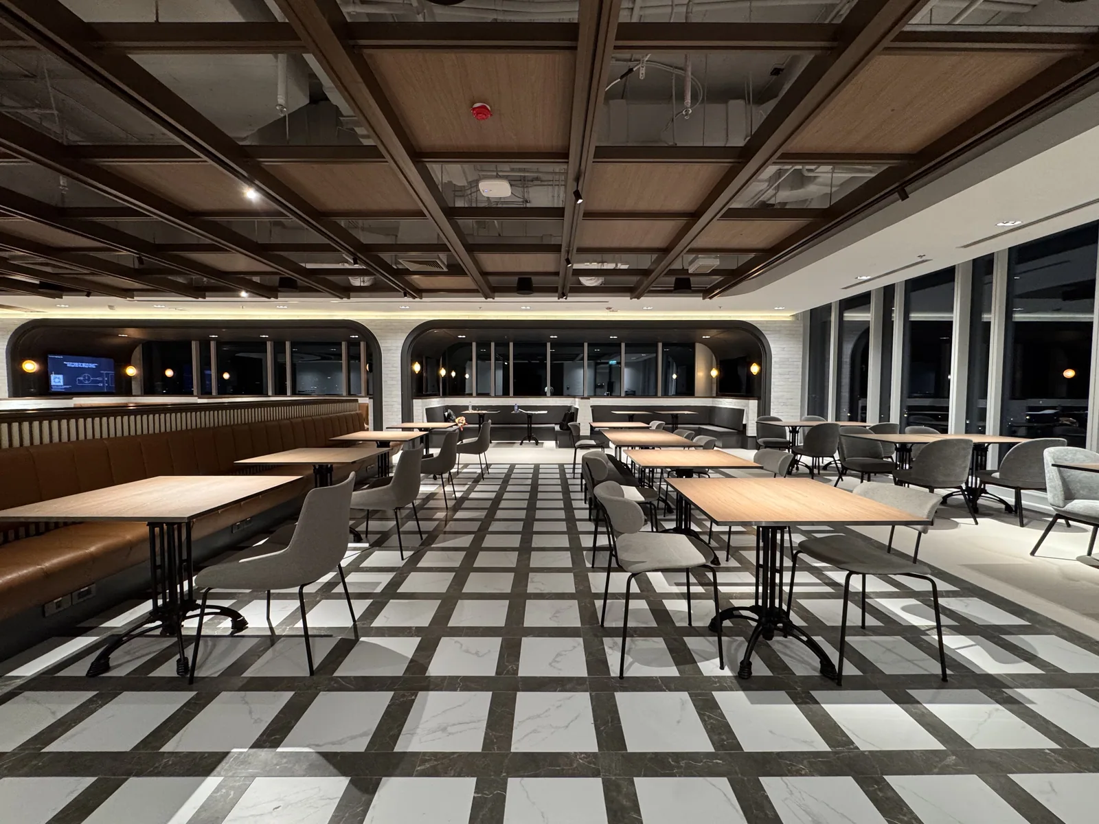 A completed staff dining area with banquette seating and a marble tiled floor