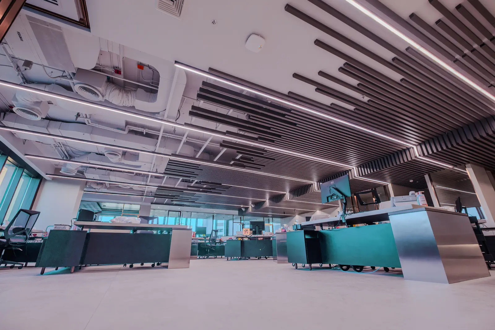 Desk floor beneath an exposed slatted ceiling with skyline view