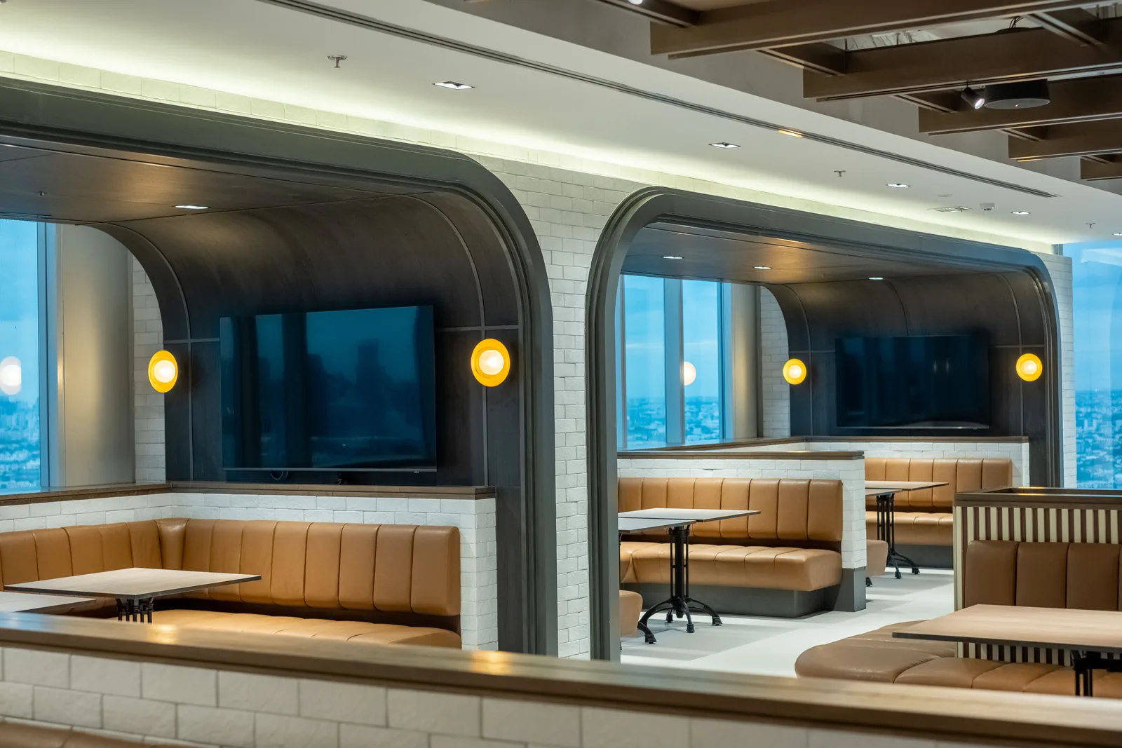 Arched booth seating with feature pendants in a corporate staff restaurant