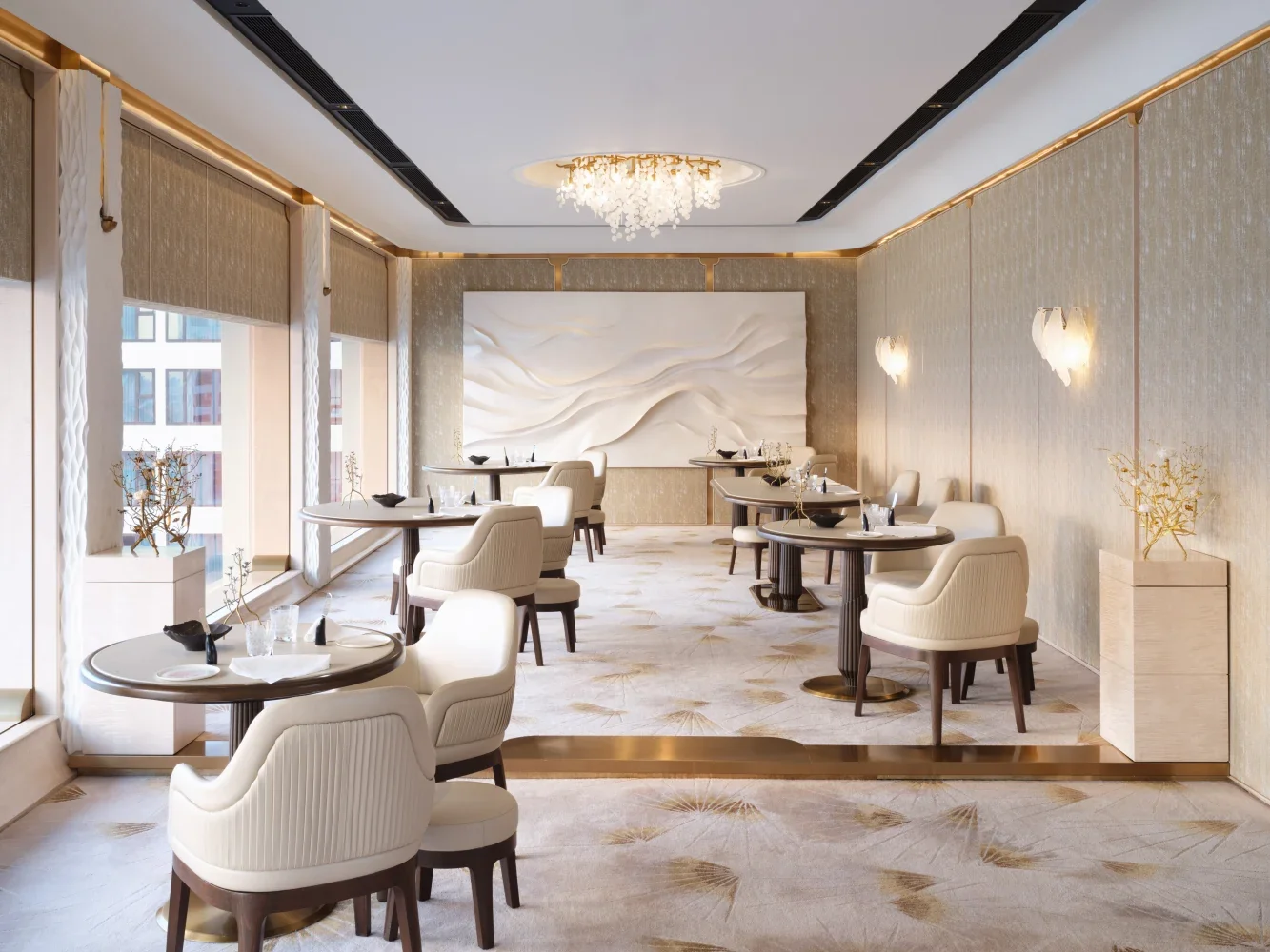 Upholstered dining chairs and round tables in a Michelin starred restaurant dining room